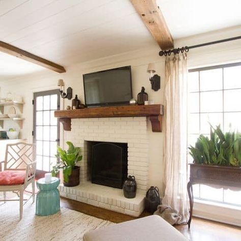 This one has a ton of charm. I love that the fireplace appears to sit on top of the shiplap wall instead of designed to be included with the wall. The mantel also stands alone, which is a very unique feature. Most corbels and mantels are built to fit within the width of the fireplace. These over-sized corbels actually attach to the shiplap wall, not the fireplace wall. This creates a more authentic look versus a modern look. Brick Fireplace Mantles, Diy Fireplaces, White Brick Fireplace, Painted Brick Fireplace, Indoor Outdoor Fireplaces, Traditional Family Room, Living Colors, Wood Mantle, Wood Mantel