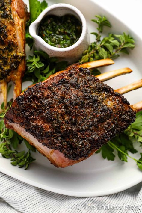 This roasted rack of lamb is coated with a blend of fresh herbs and then roasted to perfection. The result is a delicate crust on the outside, with a tender and juicy inside. Served alongside a vibrant mint chimichurri, this dish lets the natural flavors of the lamb take center stage so you can savor every bite. #theendlessmeal #lamb #rackoflamb #roastedlamb #roastedrackoflamb #dinner Roasted Rack Of Lamb Recipes, Rack Of Lamb Recipes, Lamb Recipes Oven, Mint Chimichurri, Roasted Rack Of Lamb, Roast Rack Of Lamb, Lamb Chop Recipes, Single Serving Recipes, Rack Of Lamb