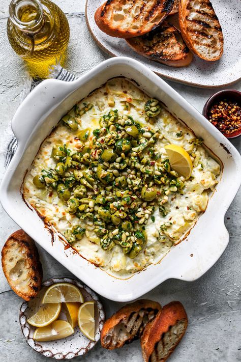 Creamy Baked Feta and Artichoke Dip with Olive Gremolata dip served as an appetizer. Castelvetrano Olives, Artichoke Pasta, Baked Feta, Party Dip, Feta Dip, Sandwich Spread, Pita Chips, Artichoke Dip, Artichoke Hearts