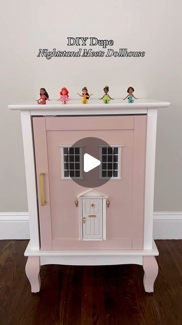 Morgan on Instagram: "An easy DIY for this functional decor piece. This dupe cost roughly $120 compared to the $450 PB one that inspired us. 

All you need is:
- a nightstand with a single door that pulls open
- paint
- fairy door
- dollhouse windows 
*optional multi tool to cut out the windows and doors to make them functional*

We added left over peel and stick wallpaper to spruce up the inside of the door and cover some of the cut outs. It was a win win! 

The dollhouse is perfect for play or storage! What do you think?! 

#dollhousenightstand #diymom #kidsroommakeover #diyhomedecor #diyhomeprojects #toddlermom #dollhouse #girlmom #toddlerroom #toddlerroomdecor 
DIY doll house | kids room DIY | crafty mom | toddler girl mom" Dollhouse Nightstand Diy, Paint Fairy, Dollhouse Windows, Dollhouse Door, House Kids Room, Diy Doll House, Diy Nightstand, Kids Rooms Diy, Toddler Room Decor