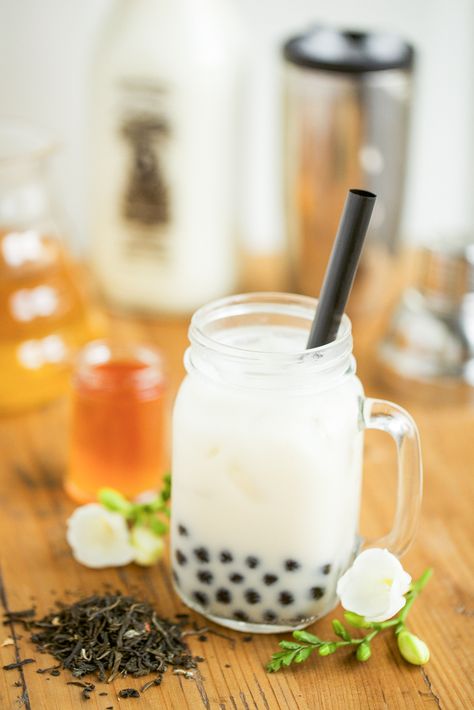 So, are you a boba tea lover? While insisting that they love tea, I have a few friends who can't stand boba milk tea. Is it the squishy, chewy texture of those tapioca balls that turn them off? Maybe poor quality tea? Perhaps a bad proportion of tea to milk? Whatever the reason, I'm hoping that this recipe for Jasmine Tea with Honey Boba might turn things around. This recipe comes straight from The Boba Guys themselves. If you don't already know of them, they're a company base... Easy Bubble Tea Recipe, Jasmine Milk Tea, Honey Boba, Asian Bakery, Recipes Deserts, Tea With Honey, Iced Tea Recipes Homemade, Bubble Tee, Homemade Iced Tea