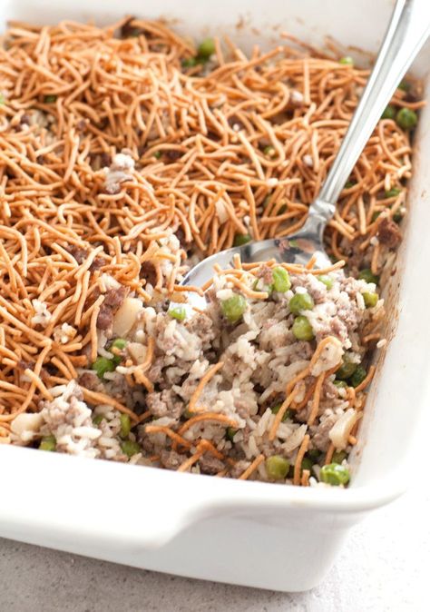 Asian Beef and Rice Casserole with crispy chow mein noodles and serving spoon Asian Beef And Rice, Beef And Rice Casserole, Crispy Chow Mein Noodles, Beef Chow Mein, Chinese Beef, Hotdish Recipes, Ground Beef Casserole Recipes, Chow Mein Recipe, Rice Casserole Recipes