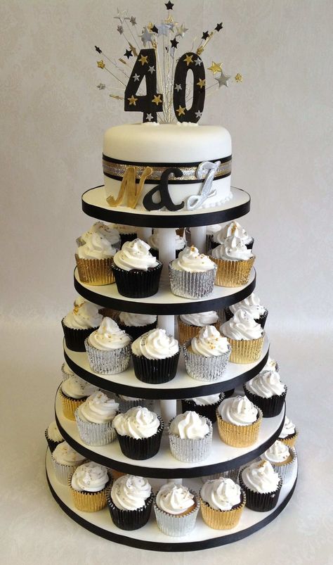 Black, gold and silver Cup Cake tower Black And Silver 60th Birthday Ideas, Silver And Gold Birthday Cake, Black Gold Silver Cake, Gold And Silver Cupcakes, Black Gold Silver Party Decorations, Black Gold And Silver Party Decorations, Black And Gold Cupcakes Birthdays, Black And Silver Cakes Birthday, Gold And Silver Cake