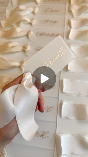 Frankie H on Instagram: "For C + A at the gorgeous @otleyhall yesterday ✨

Recycled frosted acrylic place cards, hand calligraphed in Gold ink, finished with Ivory silk ribbon ✨

Venue @otleyhall
Floral design @the.fleurgirl
Decor and On the Day Styling @partysquared_weddings
Cake design and favours @onepartlovebakery
Fabric signs, place names & table numbers @bewilderly
String quartet @scintillostringquartet
Photography @thymelanephoto
Content creation @the_wedit_
Chair, linens & tableware @banquetinghire_official
Caterers @reevesevents
Entertainment @the.photobay and @dilee_jentertainments

#placecards #weddingplacecards #acrylicplacecards #onthedaystationery #weddingstationery #silkribbon" Acrylic Wedding Name Place Cards, Acrylic Place Cards, Linen Tableware, Name Place Cards, Frosted Acrylic, Wedding Name, Ivory Silk, String Quartet, Place Names