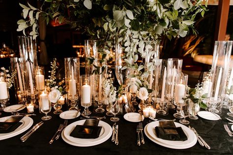 Reception tables were covered with black linens and decorated with high and low arrangements of white flowers with ample greenery, illuminated with candlelight… White And Gold Wedding Table, Wedding Table Black, Black Wedding Reception Decor, Poolside Wedding Ceremony, Black Tablecloth Wedding, Black Wedding Table Setting, Black Wedding Reception, Black White And Gold Wedding, Black Wedding Table