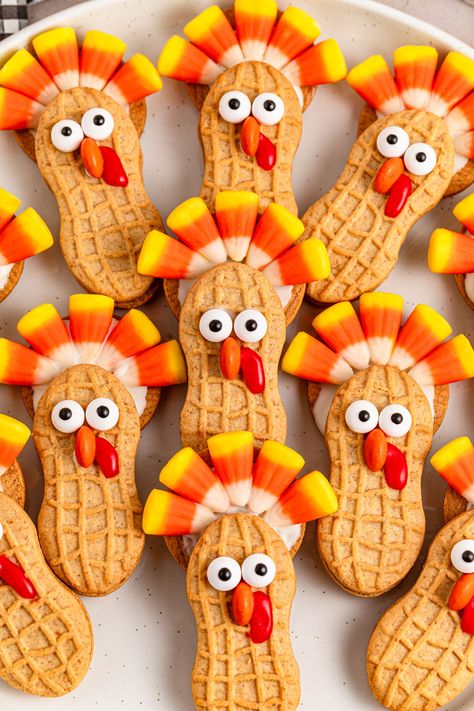 Nutter Butter Turkeys are a fun and festive no-bake treat that's perfect for Thanksgiving celebrations. These adorable cookie creations use classic Nutter Butter cookies, candy corn, and chocolate to make cute turkey shapes that kids and adults alike will love. Ideal for holiday parties, classroom treats, or a fun kitchen project with the family, these easy-to-make Nutter Butter Turkeys add a playful touch to your dessert spread. Enjoy the sweet and whimsical charm of these turkey-themed treats that bring the holiday spirit to life! Butter Turkey, Peanut Butter Sandwich Cookies, Candy Wafers, Thanksgiving Desserts Table, Turkey Treats, Turkey Cookies, Candy Eyeballs, Nutter Butter Cookies, Peanut Butter Sandwich