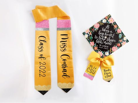 "With fast shipping and a personalized design, our coordinating stoles, bows, and cap toppers are the perfect way to personalize the big day! Select just one item, a combination of two, or all three! Combinations of 2+ items reflect a $5 off discount. Stole, Bow, and Topper are all personalized with your choice of text- include a quote, name, monogram, year, school, degree, or any short message! Bow and Stole are finished with glittering pencil accents and glittery black custom text. Topper is p Teacher Graduation Sash, Teacher Graduation Stole, Teacher Cap Decoration Graduation, Graduation Cap Decoration Teacher, Master's Graduation, Education Graduation Cap, Teacher Graduation Cap, College Inspiration, Teacher Graduation