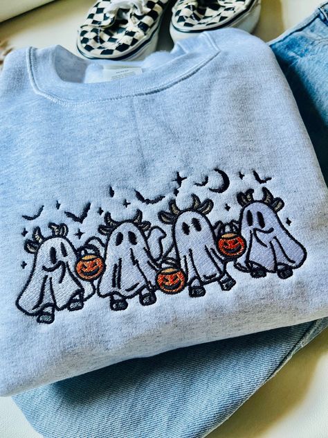 the cutest spooky cow ghost embroidered design on a Hanes Eco Smart / Gildan Crewneck! message the shop for sweatshirt upgrade! Fall Sweatshirt Ideas, Halloween Embroidery Crewneck, Casual Halloween Sweatshirt With Custom Embroidery, Cute Cotton Halloween Sweatshirt, Spooky Season Crewneck, Cow Ghost, Spooky Crew Neck Sweatshirt For Fall, Crewneck Aesthetic, Cute Jumpers