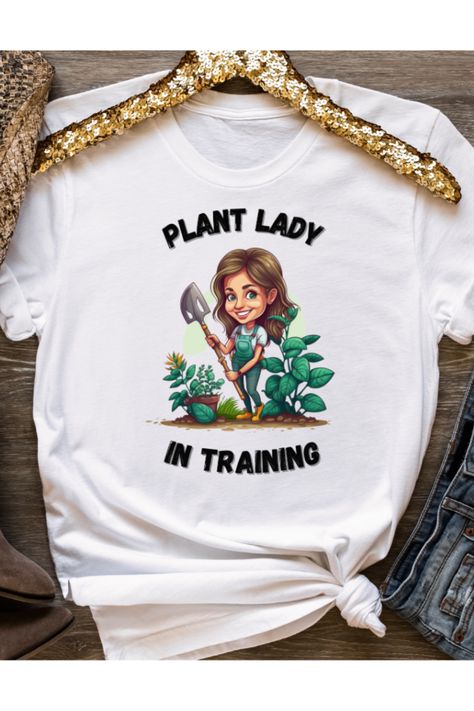 This "Plant Ladyl" t-shirt is a must-have for anyone who loves plants and gardening. The shirt features the catchy phrase "Plant Lady" printed on it, making it a perfect way to show off your green thumb and love for nature. Made from high-quality materials, this shirt is comfortable to wear and easy to care for. Plant Shirt Design, Plant Shirts, Plants And Gardening, Plant Store, Garden Shirt, Catchy Phrases, Master Gardener, Gardening Shirts, Plant Lady