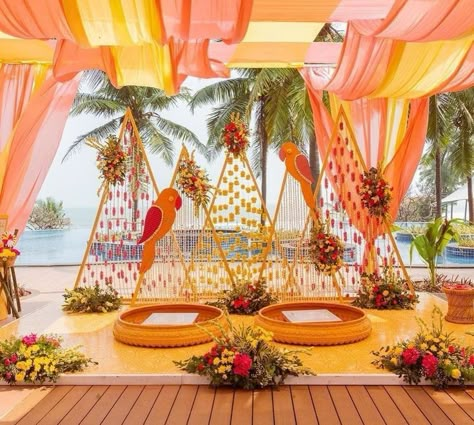 Go beyond the classic marigold and incorporate a vibrant array of climbing flowers to create stunning archways and backdrops for your Haldi stage. This captivating floral installation can be further enhanced with an oversized wedding hashtag prop. Pithi Decoration, Haldi Backdrop, Haldi Decorations, Haldi Decor Ideas, Haldi Ideas, Shaadi Decor, Haldi Decoration Ideas, Haldi Ceremony Decorations, Small Wedding Decor