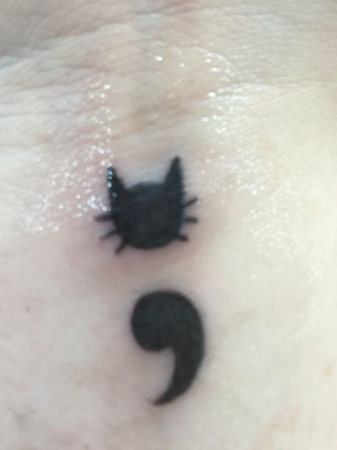 Here's an up close picture of my first tattoo. It's a cat semicolon. Coraline Stick And Poke, Cat Semi Colon, Cat Behind Ear Tattoo, Semicolon Cat Tattoo, Cat Tattoo Designs Memorial, Cat Tattoos Memorial, Cat Tattoo Behind Ear, Cat Tattoo Memorial, Cat Mom Tattoo