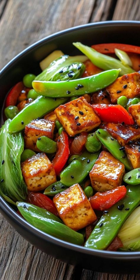 Dive into a vibrant world of flavors with my Crispy Vegetarian Tofu Stir-Fry! Packed with colorful vegetables and perfectly crispy tofu, this dish is a delightful balance of health and taste. It's quick to make, making it perfect for busy weeknights or a meal prep staple. Trust me, your taste buds will thank you! #Vegetarian #TofuStirFry #HealthyRecipes Black Pepper Tofu And Green Beans, Crispy Tofu Stir Fry Recipe, Tofu Breakfast Recipes, Tofu Stir Fry Recipe, Rotini Pasta Salad, Stir Fry Veggies, Pumpkin Cream Cheese Bread, Pork Chop Recipes Grilled, Tofu Breakfast