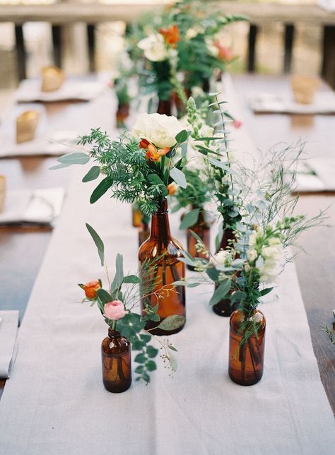 Empty Glass Bottles Fill In As Gorgeous Wedding Centerpieces Glass Bottles Wedding, Beer Themed Wedding, Bottle Centerpieces, Rustic Wedding Decorations, Deco Champetre, Flowers And Greenery, Beer Theme, Budget Friendly Wedding, Wedding Bottles