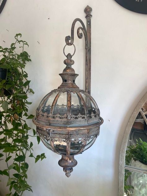 A gorgeous, intricately detailed wall hanging lantern. Comes complete with the bracket  This lantern has been made to look antiqued, it really is a beautiful garden feature. Opens in the centre to put your own candle/solar light inside.  Looks magical either side of a front door/lighting up the garden fence/round a garden patio setup! Has a very expensive, luxurious look to it ALL OUR BRACKET LANTERNS SENT BY DPD NOW Measurements: Bracket - Length 50cm  Depth (the amount it comes out from wall) Outdoor Lanterns Patio, Wall Hanging Lanterns, Exterior Illumination, Patio Setup, Door Lighting, Detailed Wall, Front Door Lighting, Hanging Light Lamp, Hanging Candle Lanterns