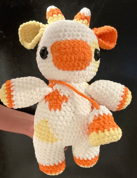 A PATTERN for this adorable, cuddly, candy corn-themed cow!! It is perfect for Halloween and spooky season. I used Bernat blanket yarn and a size 7.00 mm hook! The cow is 20 inches tall and has a 13-inch wingspan. Candy Corn Cow Crochet, Candy Corn Blanket Crochet, Candy Corn Crochet Pattern, Candy Corn Bat Crochet, Halloween Crochet Candy Corn, Bernat Blanket Yarn, Blanket Yarn, Fun Crochet Projects, Halloween Patterns