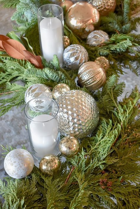 Silver and Gold Christmas Centerpiece with Evergreens - Home with Holliday Real Fireplace, Christmas Party Centerpieces, Evergreen Garland, Cocktail Table Decor, Silver And Gold Christmas, Real Candles, Red And Gold Christmas Tree, Christmas Cones, Christmas Vignettes