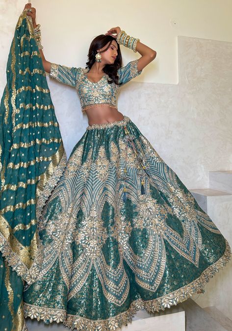 Item: Lehenga Set ( Lehenga Skirt, Blouse and Dupatta) The Sage Green Jacquard Lehenga Set is a sight to behold, with its intricate embroidery and jacquard fabric. It's fully customizable, allowing you to create a piece that's uniquely yours. It's the perfect Indian wedding dress for a day wedding or a dazzling reception, making you the most beautiful woman in the room. The Sage Green imbibes a princess-like aura, with intricate embroidery that creates a timeless and romantic look that is sure t Green And White Indian Outfit, Tamil Lengha, Brown Lehenga Designs, Olive Green Indian Outfit, Wedding Fits Indian, Princess Jasmine Inspired Lehenga, Bridal Engagement Lehenga, Matching Indian Outfits For Couples, Indian Bridal Lehenga Green