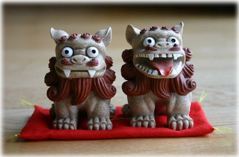 Shisa (シーサー) (Okinawan: siisaa) (shishi or shisaa) is a traditional Ryukyuan decoration, often in pairs, resembling a cross between a lion and a dog, from Okinawan mythology. People place pairs of shisa on their rooftops or flanking the gates to their houses. Shisa are wards, believed to protect from some evils. When in pairs, the left shisa traditionally has a closed mouth, the right one an open mouth. The open mouth wards off evil spirits, and the closed mouth keeps good spirits in. Shisa Dog, Bamboo Grove, Strange Beasts, Stone Lion, Fu Dog, Lion Dog, Okinawa Japan, Japan Culture, Foo Dog