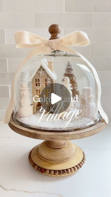 Stephanie Hanna on Instagram: "DIY Cake Stand Village❄️ Use your cake stand for a sweet little village scene. If you don’t have one, Home Goods has a ton lately! Fill it with fake snow, a little house and a few bottle brush trees for the easiest festive centerpiece. . . . . . . . #diyhomedecor #diychristmas #diyprojects #diycrafts #homegoodsobsessed #homegoodsfinds #homegoodshappy"