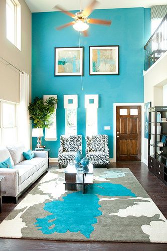 Talk about a beautiful living room with stunning blue paint! Find a home that can handle your fun personality and decor style here in Austin, Texas. Turquoise Accent Wall Living Room, Light Blue Accent Wall Living Room, Bright Blue Accent Wall, Accent Rugs Living Room, Blue Paint Living Room, White And Blue Rug, White Carpet Living Room, Cathedral Ceiling Living Room, Blue Accent Wall