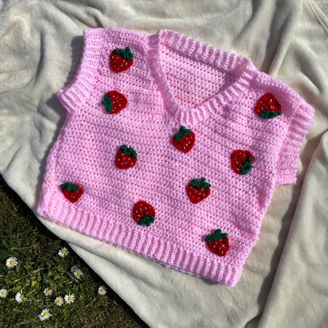 a pink sweater vest with little strawberry appliqués Crochet Sweater Strawberry, Crochet Strawberry Cardigan, Cute Strawberry Sweater, Cozy Cardigan Outfit, Knit Strawberry Sweater, Knitted Sweaters Strawberry, Crochet Sweater Vest, Crochet Fashion Patterns, Diy Crochet Projects