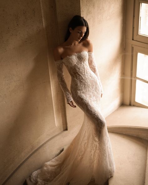 Embodiment of timeless elegance and romance. The Fall/Winter 2025 collection proposes a new vision for the modern bride with the #Charlotte gown, a mermaid silhouette featuring a straight neckline and graceful off-the-shoulder sleeves. Made from exquisite lace and adorned with intricate beaded details, this gown captures the essence of luxury. Complemented by a matching veil, the Charlotte gown embodies the enchanting beauty and profound emotions of the bridal journey. #LPGfall25 #BridalCou... Wedding Dresses Sofia Richie, 2025 Bride Dress, Lace Fit And Flare Wedding Dress, Spain Wedding Dress, Lace Off Shoulder Wedding Dress, Bridal Dresses With Sleeves, Paolo Sebastian Wedding Dress, Lace Wedding Dress Long Sleeve, Feminine Wedding Dress