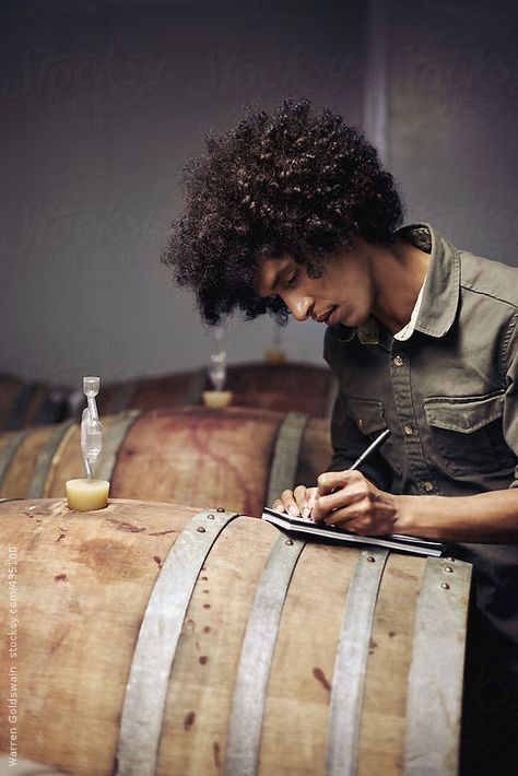 Artisan winemaker recording samples in the cellar filled with oak wine barrels Winemaker Aesthetic, Winemaking Aesthetic, Winemaker Photography, Wine Maker Photography, Winemaker Portrait, Wine Portrait, Wine Lifestyle Photography, Liqour Aesthetics Photography, Distillery Photography