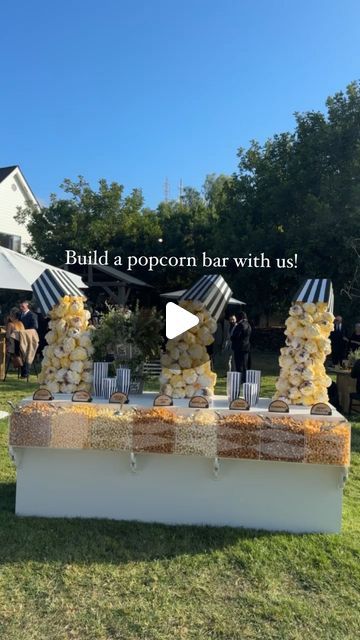 Revelry Event Designers on Instagram: "Ready for a pop of fun? 🍿

This custom popcorn bar was a crowd favorite at this ranch wedding! Our carpentry team crafted unique popcorn sculptures which we hand-painted for a playful look. With eight different flavors to choose from, it was a tasty, creative twist that guests couldn’t get enough of! 

The Team |
Planning & Design: @eventlab1
Event Design & Custom Bar: @revelryeventdesign @revelrymilana
Floral Design: @butterfloral @butterflyfloral_yvonne
Lighting & AV: @images_lighting @rayoflighting
Signage: @velvetfoxdesigns
Popcorn: Laguna Popcorn

#revelryeventdesign #custombar #customweddingdecor #popcornbar #eventbar #weddingdecor #weddingdecorideas #luxuryeventdesign #luxuryweddingdesign #customeventdecor #eventrentals #weddingbar #weddingbts Make Your Own Popcorn Bar, Popcorn Buffet Ideas, Popcorn Wedding Bar, Event Bar Design, Popcorn Bar Wedding, Wedding Popcorn Bar, Popcorn Buffet, Party Food Bars, Popcorn Wedding