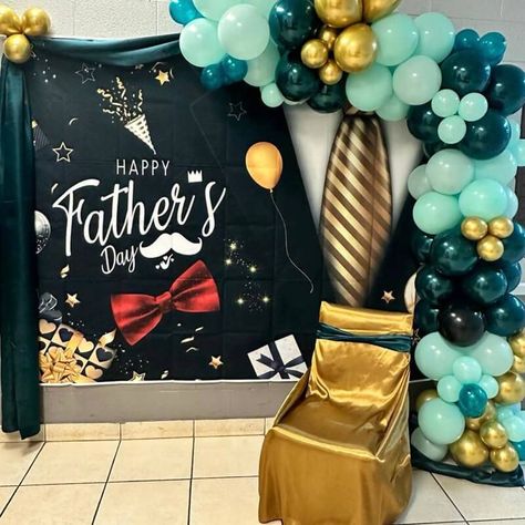 Celebrate fathers in style with a marvelous Father's Day backdrop! Imagine a beautifully printed tarpaulin gracing the wall, exclaiming "Happy Father's Day" in vibrant colors. Embellished with a luxurious teal silk drape and a garland of turquoise, teal, and gold latex balloons, it creates a striking backdrop that captures the essence of the occasion. A chair, dressed in a regal gold silk cover, is adorned with a teal silk chair sash, offering a throne fit for a king. Fathers Day Balloon Backdrop, Fathers Day Backdrop, Father’s Day Photo Back Drop, Father’s Day Backdrop For Church, Father’s Day Balloon Display, Father’s Day Backdrop, Chair Sash, Balloon Backdrop, Gold Silk