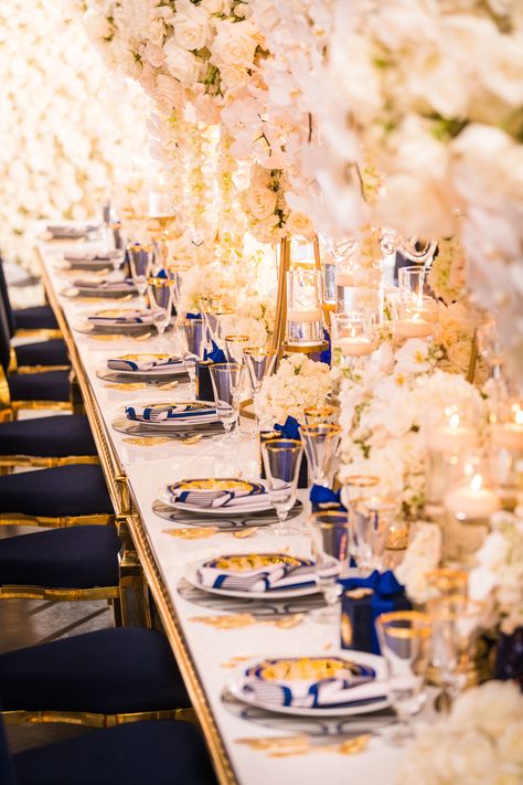 24 Winter Wedding Centerpieces for a Chic Off-Season Event. See why so many couples are opting for a winter wedding. Snow Wedding Centerpieces, Blue Winter Wedding Table Decorations, Winter Wedding High Centerpieces, Blue And Gold Wedding Reception, Blue And White Winter Flower Arrangements, Royal Blue And Gold Wedding, Winter Wedding Floral Installation, Blue And Gold Wedding, Gold Wedding Reception