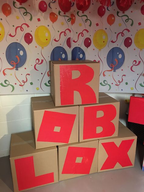 Moving boxes and paper letters glued on Roblox Box Ideas, Roblox Birthday Party Ideas Printables, Birthday Roblox Party Ideas, Roblox Birthday Party Ideas Decor, Roblox Party Ideas For Boys, Diy Roblox Party Decorations, Roblox Decoration Ideas, Roblox Birthday Party Ideas For Boys, Roblox Birthday Decorations