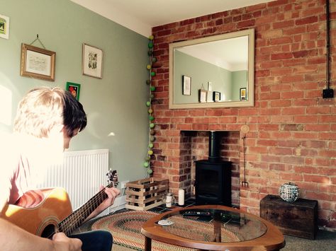 Front room. Bare brick. Charnwood Stove. Large Over-Mantel Mirror. Sage Green. Rag rug. Charnwood Stove, Brick Accent Wall Bedroom, Bedroom Brick Wall, Sage Living Room, Fake Brick Wall, Brick Cafe, Brick Wall Living Room, Brick Fireplace Wall, Sage Green Living Room