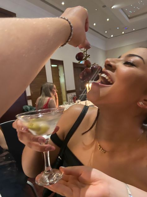 girl being fed red grapes while holding a martini glass with olives in it Eating Grapes Aesthetic, Nye Grapes, New Years Grapes, Wine Girl Aesthetic, Grapes Aesthetic, Fruit Grapes, Business Vision Board, Business Vision, Light Blue Aesthetic