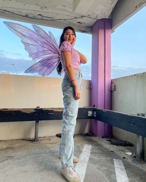 Girl standing in a garage, with long curly hair and a pair of purple butterfly wings Fairy Inspired Outfit, Fairycore Outfit, Modern Fairy, Creepy Costumes, Trendy Spring Outfits, Halloween This Year, 2021 Fashion, Trendy Outfit, Wide Jeans