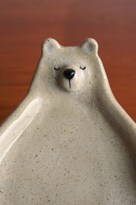 This ceramic bear dish can be used for many things. You can use it as a trinket dish to place your jewelry or as a small plate for food. It is also perfect for kids' snacks.

It is made from stoneware and covered with a transparent and shiny glaze. The used materials are food safe.

It has approximately 19 cm in length and 12 cm in width. Bear Pottery, Ceramic Bear, Ceramic Soap Dish, The Used, Small Plate, Ceramic Animals, Kids Snacks, Small Plates, Trinket Dish