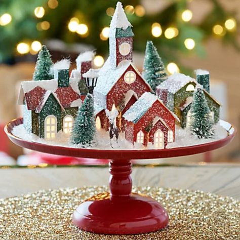 10 Ways to Jump-Start Your Home’s Holiday Spirit Christmas Village On Cake Stand, Snowy Christmas Village, Mr Christmas, Snowy Christmas, Christmas Table Centerpieces, Christmas Village Display, Christmas Centerpieces Diy, Village Display, Twinkling Lights