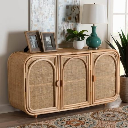 Invigorate your space with the exotic serenity of the Evania storage cabinet. Made in Indonesia, this bohemian piece is handcrafted from natural rattan by skilled artisans. The doors open to reveal two spacious interior shelves that adeptly organize and declutter busy areas of your home while reserving the wide tabletop for decor. The Evania will arrive fully assembled and features beautifully woven exteriors to create a light, airy display from any angle. Elongated wood handles further add to the eye-catching presentation, making the Evania storage cabinet a striking addition to any arrangement. Disclaimer: Rattan is a product of nature and may have variations in areas such as, but not limited to, color, pattern, grain and texture. The hair-like strands of rattan/rattan-fiber are common d Modern Mexican Home Decor, Organize And Declutter, Sunroom Furniture, Wicker Dining Set, Interior Shelves, Wicker Dining Chairs, Patio Lounge Chairs, Wood Handles, Living Room Bookcase