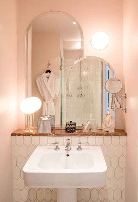 Cotton-candy-colored walls are matched with deep pink marble in a guest bath at Hotel des Grands Boulevards in Paris. (For more, see our feature on the interiors: Beds Take a Bow: The New Grands Boulevards Hotel in Paris.) Paris Hotel Interior, Coral Pink Bathroom, Modern Pink Bathroom, Bathrooms Modern, Mini Bad, Hotel Interiors, Pink Bathroom, White Bathroom, Cheap Home Decor