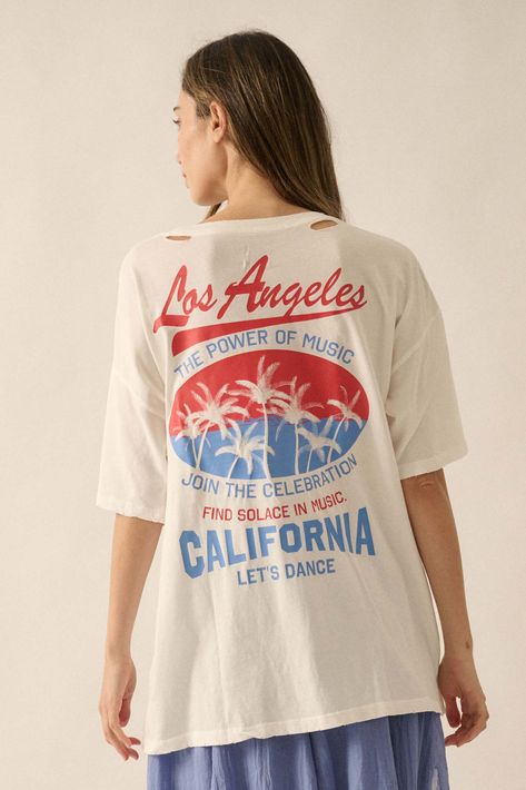 Distressed, garment washed graphic t-shirt. Torn and distressed detailing at neckline, cuffs, and hem. Back print with palm tree graphic with Los Angeles music festival text. Los Angeles chest print with wave graphic. Round neckline. Short sleeves. Drop shoulder. Oversized fit. 100% Cotton. Imported top designed and printed in LA. Model wears size S. Oversize Graphic Tee, Palm Tree Graphic, Wave Graphic, Oversized Graphic Tee, Tree Graphic, Product Ideas, Vintage Canvas, Palm Tree, Music Festival