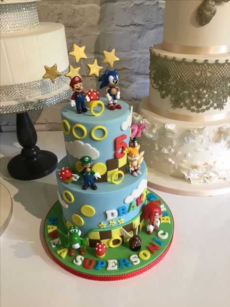 Super mario and sonic cake Super Mario And Sonic Cake, Sonic And Mario Birthday Cake, Sonic Vs Mario Cake, Mario Sonic Cake, Sonic And Mario Birthday Party, Mario And Sonic Birthday Party, Mario And Sonic Cake, Super Sonic The Hedgehog, Mario And Sonic