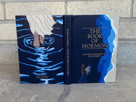 This is a hand-painted hard cover Book of Mormon with acrylic paint and protected with sealant! Perfect gift for family, friends, and missionaries! It was so fun to create. Ever since my mission in Alaska I have been painting more and more. I hope you enjoy my creations! Hand Painted Book Of Mormon Cover, Simple Book Of Mormon Painting, Book Of Mormon Cover Painting Ideas, Painted Book Of Mormon Cover For Boys, Book Of Mormon Painting Ideas, Painting Book Of Mormon, Book Of Mormon Cover Art, Painting Book Of Mormon Cover, Book Of Mormon Painting