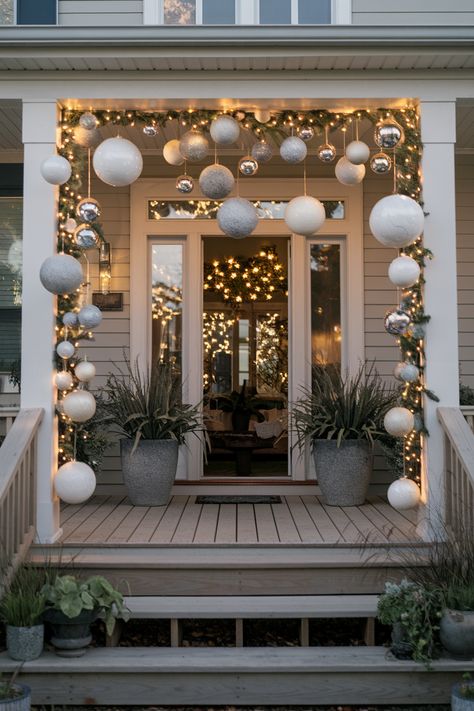 10 Modern & Classy Christmas Porch Decor Ideas Hanging Ornaments Front Porch, Modern Neutral Christmas Decor, Porch Christmas Lights, Christmas Traditions Around The World, Christmas Front Porch Decor, Holiday Front Door, Decorating A Christmas Tree, Warm White Fairy Lights, Christmas Porch Decor Ideas