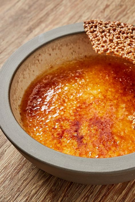 A wonderful twist on the classic crème brûlée, this dessert has tahini in the custard and a sesame seed tuile alongside, adding plenty of flavour to the perfectly set custards. The tuiles can be made in advance, and you can also cook the custards in advance too – leaving only the final caramelisation to do before serving. Tahini Creme Brulee, Sesame Dessert, Raspberry Creme Brulee, كريم بروليه, Creme Brulee Desserts, Dessert Original, Tahini Recipe, Brulee Recipe, Creme Brulee Recipe