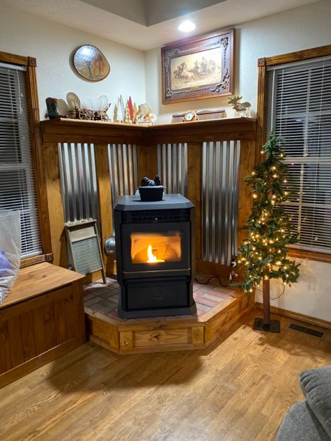 Wood Burning Stove Platform, Pellet Stove Surround Corner, Wood Stove Nook, Pellet Stove Surround Ideas, Rustic Galvanized Behind Wood Stove, Corner Hearth Pad, Corner Pellet Stove Ideas Living Rooms, Rustic Wood Stove Surround, Wood Stove Surround Corner Galvanized