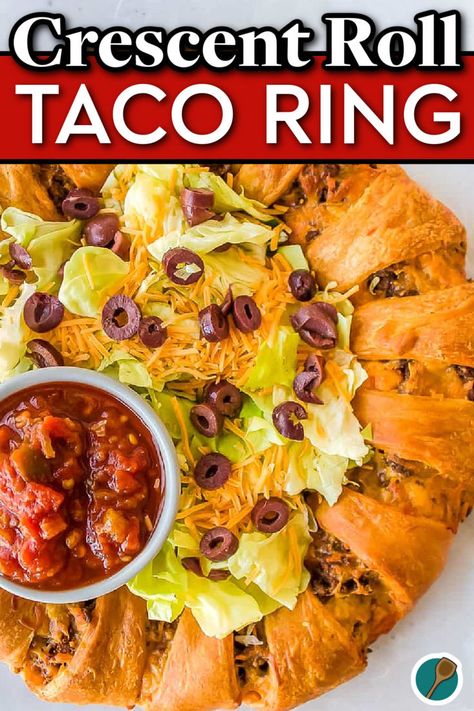 Close-up of a taco ring made with crescent rolls, topped with shredded lettuce, cheddar cheese, olives, and served with salsa. Taco Ring With Tortillas, Taco Bake Casserole With Crescent Rolls, Crescent Roll Taco Ring, Taco Ring Recipe, Crescent Roll Taco, Ring Recipes, Mexican Chicken Tacos, Crescent Ring Recipes, Taco Ring