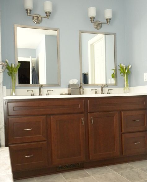 This vanity looks so crisp and clean with the contrast between the dark vanity and white top. Cherry vanity with bourban finish; Staron Radianz white diamond quartz countertop, Delta Cassidy two-handle lavatory faucet with brilliance stainless finish, Hudson Valley Windham two-light vanity fixture. Cherry Cabinets Bathroom, Dark Vanity, Dark Bathrooms, Bathroom White, Dark Wood Cabinets, Bathroom Color Schemes, Cherry Cabinets, Bathroom Paint Colors, Quartz Countertop