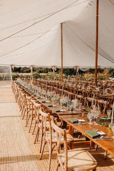 Wooden banquet tables complete with pastel green and orange candlesticks in brass antique styled holders beneath sailcloth tent Rustic Wedding Tent, Farmhouse Table Wedding, Wedding Juice, Sailcloth Tent Wedding, Sail Cloth Tent, Marquee Wedding Decoration, Wedding Floor Plan, Wedding Cocktail Tables, Wedding Table Layouts