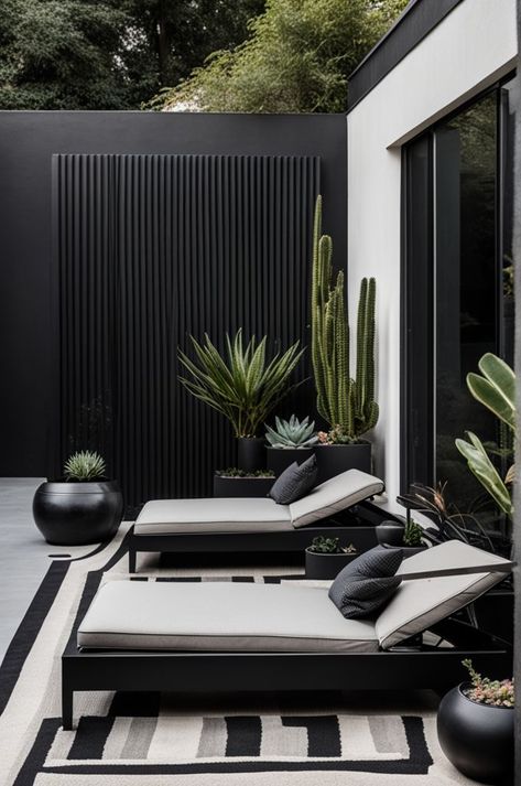 Embrace minimalism with this sleek outdoor lounge, featuring clean lines and a sophisticated black and white palette. Comfort meets style in the sun loungers, accented with textured cushions, set against a backdrop of striking desert plants. This space is a testament to modern design in harmony with nature. #MinimalistDesign #OutdoorLounge #DesertChic #ModernGarden #TexturedDecor #StylishOutdoors Textured Cushions, Barbacoa Jardin, Black And White Palette, Balkon Design, In Harmony With Nature, White Palette, Sun Loungers, Harmony With Nature, Patio Garden Design