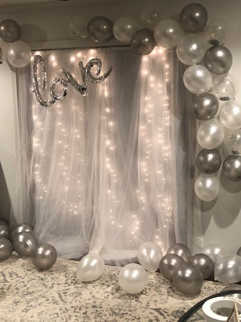 Tulle backdrop with lights + gray, gray confetti, and pearl white balloons Simple Decorations For Anniversary, Pearl White Party Decorations, White And Silver Photo Backdrop, White Themed Birthday Party Decorations, White And Shimmer Party, Birthday Decorations With Lights, White Balloon Decorations Birthday, White And Grey Birthday Decorations, Tulle Birthday Decorations