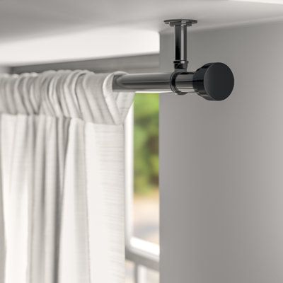 The hard part is done—you’ve picked out the perfect panels! Now it’s time to set the foundation for your drapery with this versatile single curtain rod. Crafted from metal, this tubular rod features cylindrical end caps and a solid finish for an understated and contemporary look. Mounting hardware and ceiling brackets are included, so you can install this set and hang up your curtains as soon as it reaches your door. Size: 120"- 170" L, Colour/Finish: Black Ceiling Curtains, Curtain Rod Hardware, Deco Studio, Curtain Track, Curtain Hardware, Wayfair Furniture, Drapery Rods, Door Curtain, Window Valance